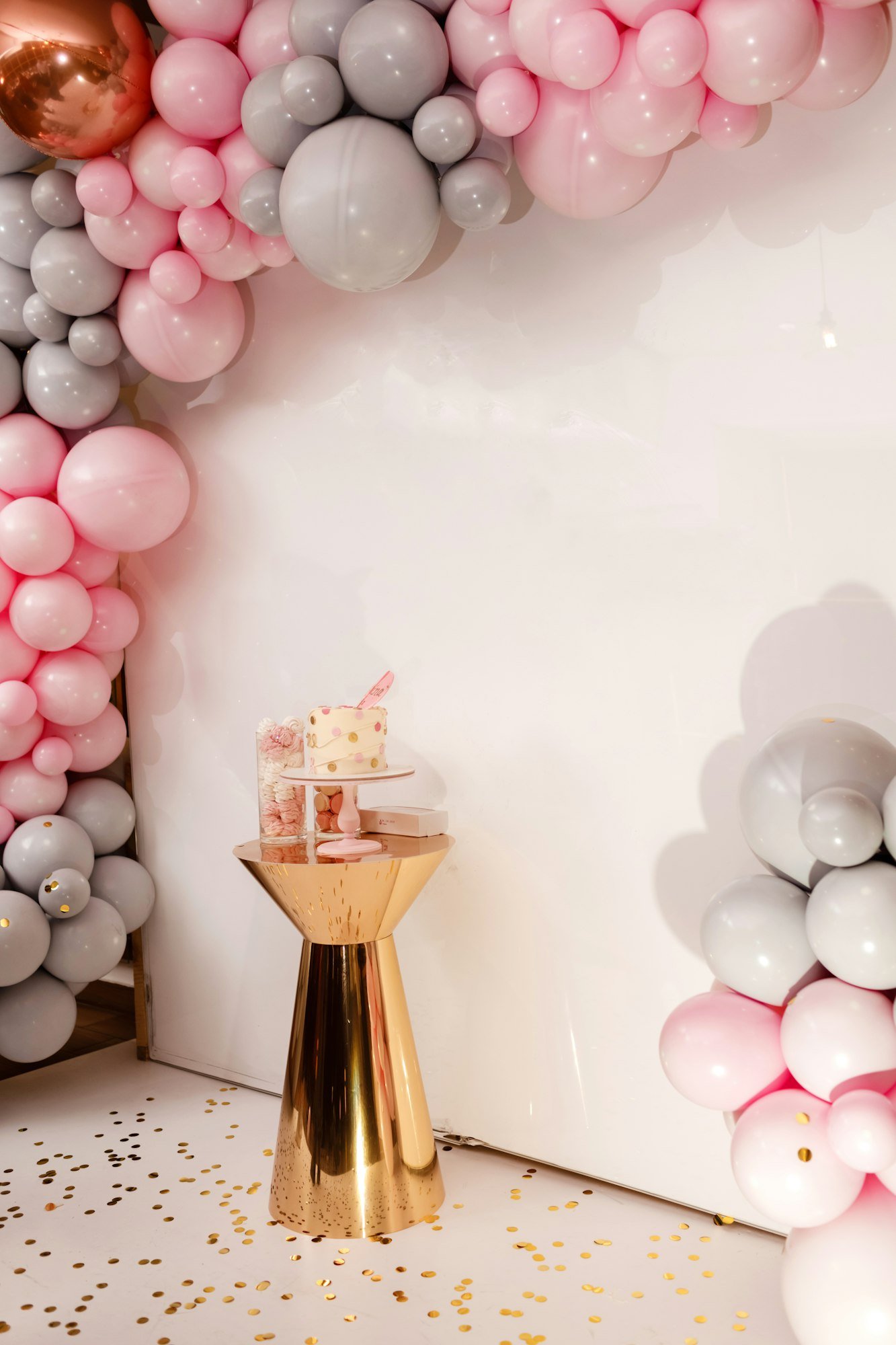 Delicious wedding reception. Birthday Cake on a background balloons party decor